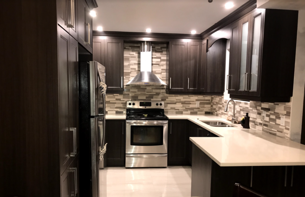 Kitchen: Dark Wood cabinets and composite counters