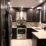 Kitchen: Dark Wood cabinets and composite counters