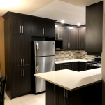 Kitchen: Dark Wood cabinets and composite counters