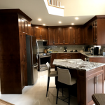 Kitchen: Wood cabinets and stone counters