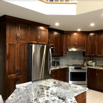 Kitchen: Wood cabinets and stone counters
